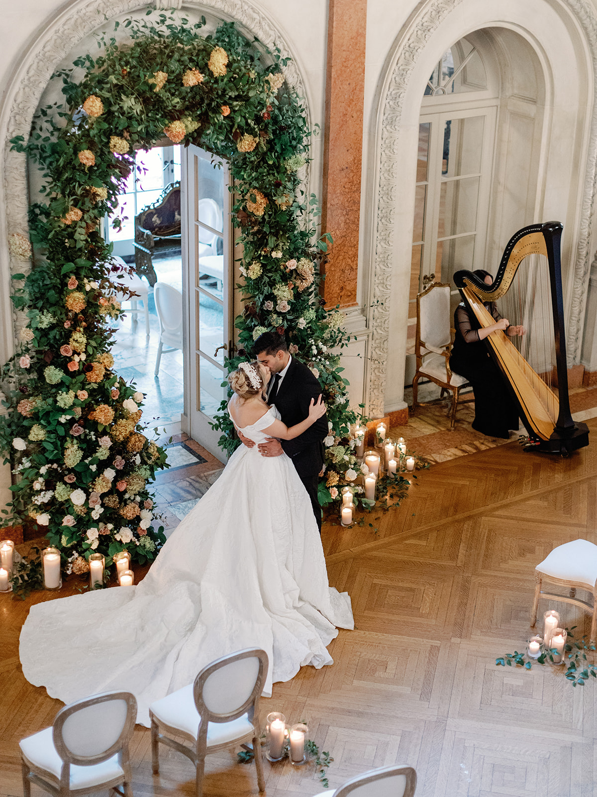 Indoor ceremony setup Larz Anderson House wedding venue in Washington DC, featuring a couple sharing their first kiss.