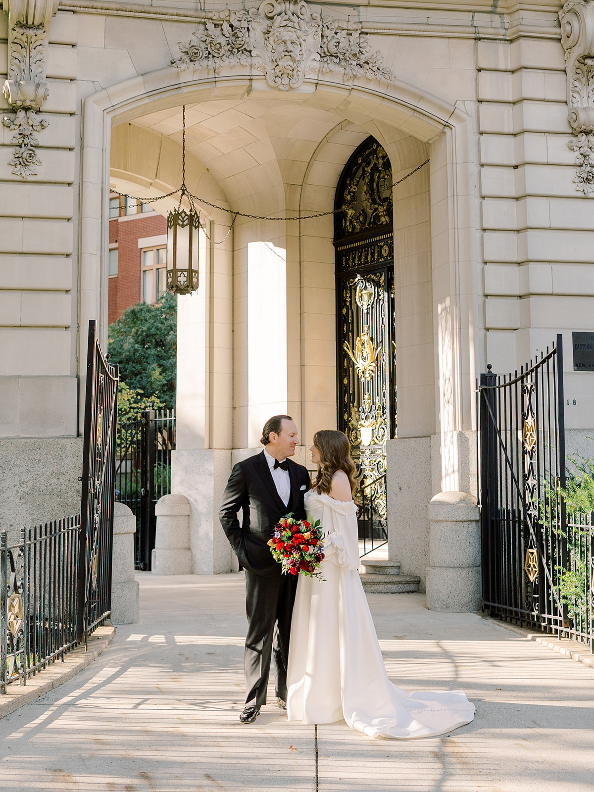 Perry Belmont House Washington DC wedding, couple posing front of building with trees.